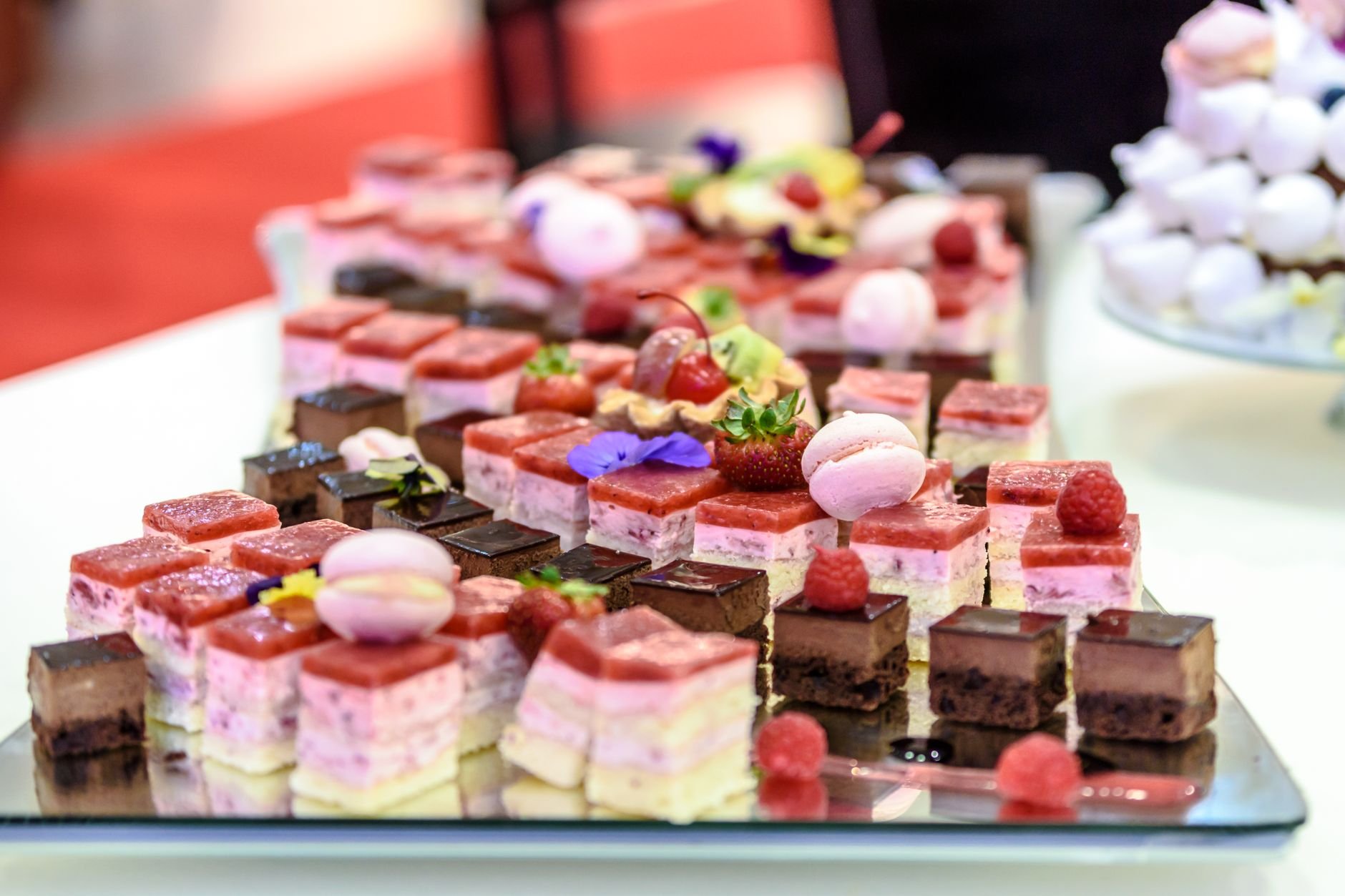 A colorful spread of gourmet pastries and desserts on a platter.